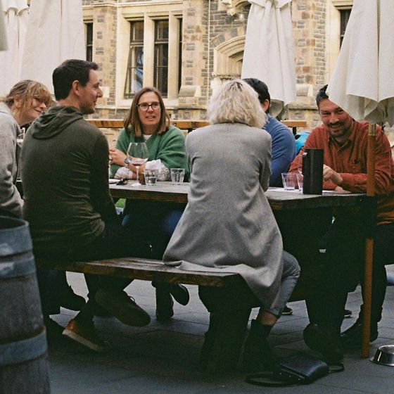 People sharing a meal at an outdoor cafe table in Christchurch